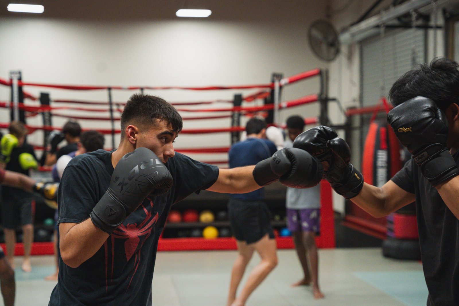 Boxing training session focusing on punch combinations and defensive maneuvers.